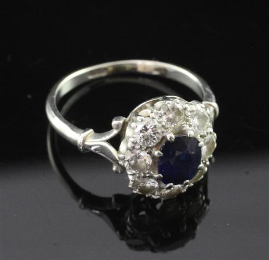 A white gold, sapphire and diamond oval cluster ring, size N.